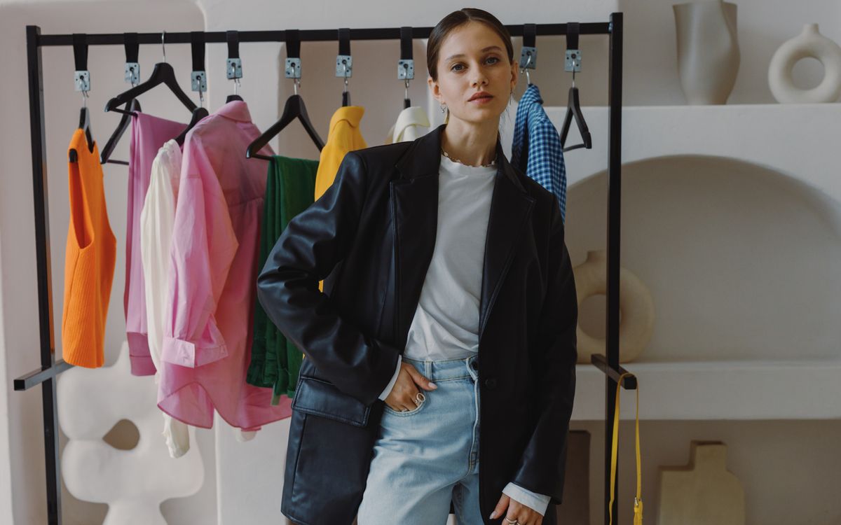 A woman in a leather jacket browsing a chic boutique