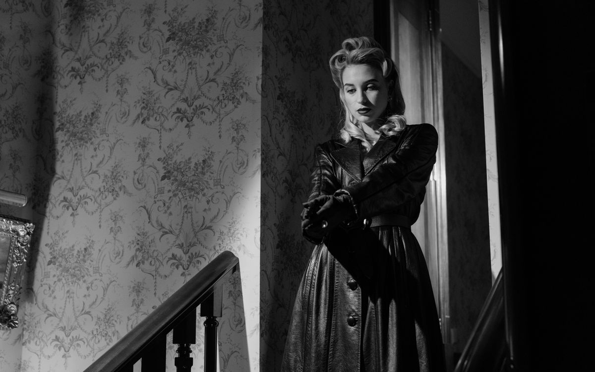 Black and white portrait of a woman in an elegant vintage leather coat