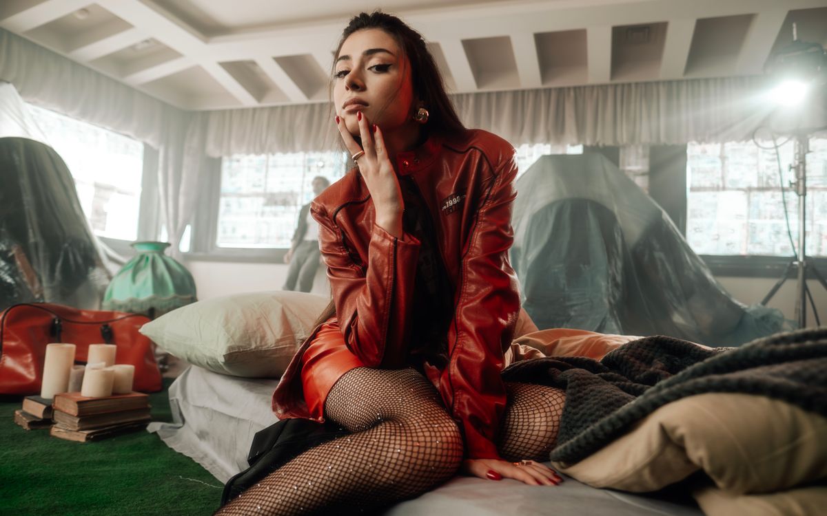 A model in a vivid red leather jacket