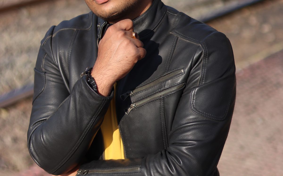 A folded summer-weight leather jacket styled with light accessories