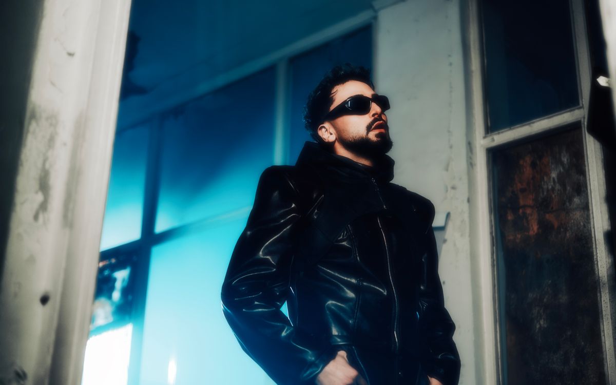 Portrait of a man wearing sunglasses and a leather jacket with a confident expression