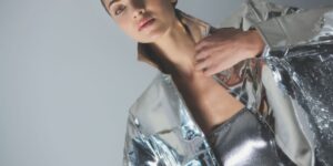Model in a shimmering silver, futuristic look under studio light