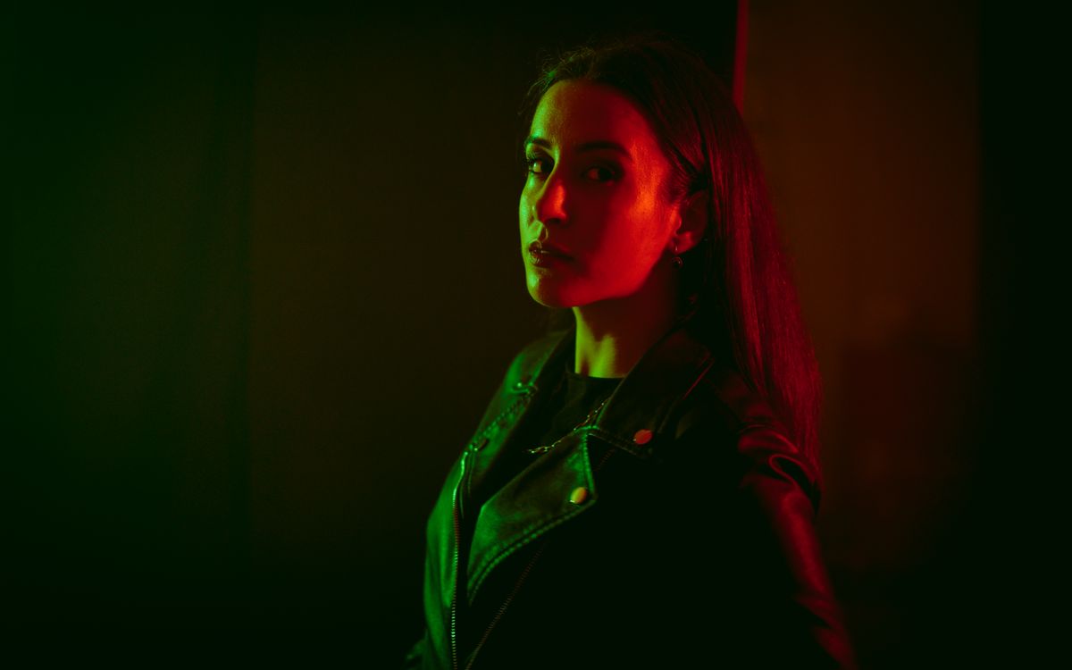Moody studio portrait of a woman in a black leather jacket