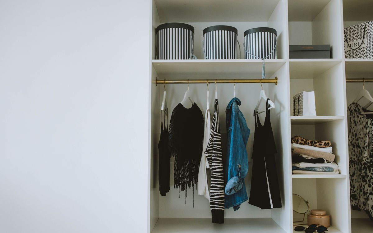 Organized wardrobe with folded clothes, hangers and neat storage boxes
