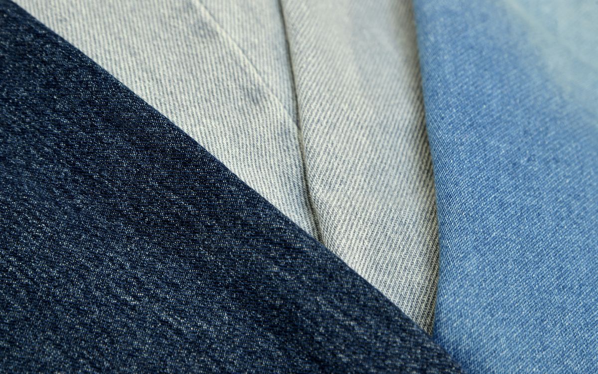 Detailed shot of blue denim fabric showing texture and stitching