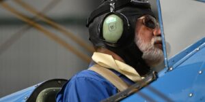 Portrait of an aviator in vintage aircraft gear preparing for takeoff