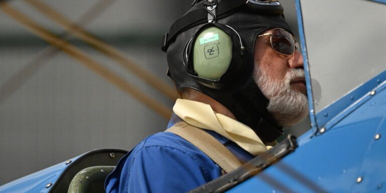 Portrait of an aviator in vintage aircraft gear preparing for takeoff