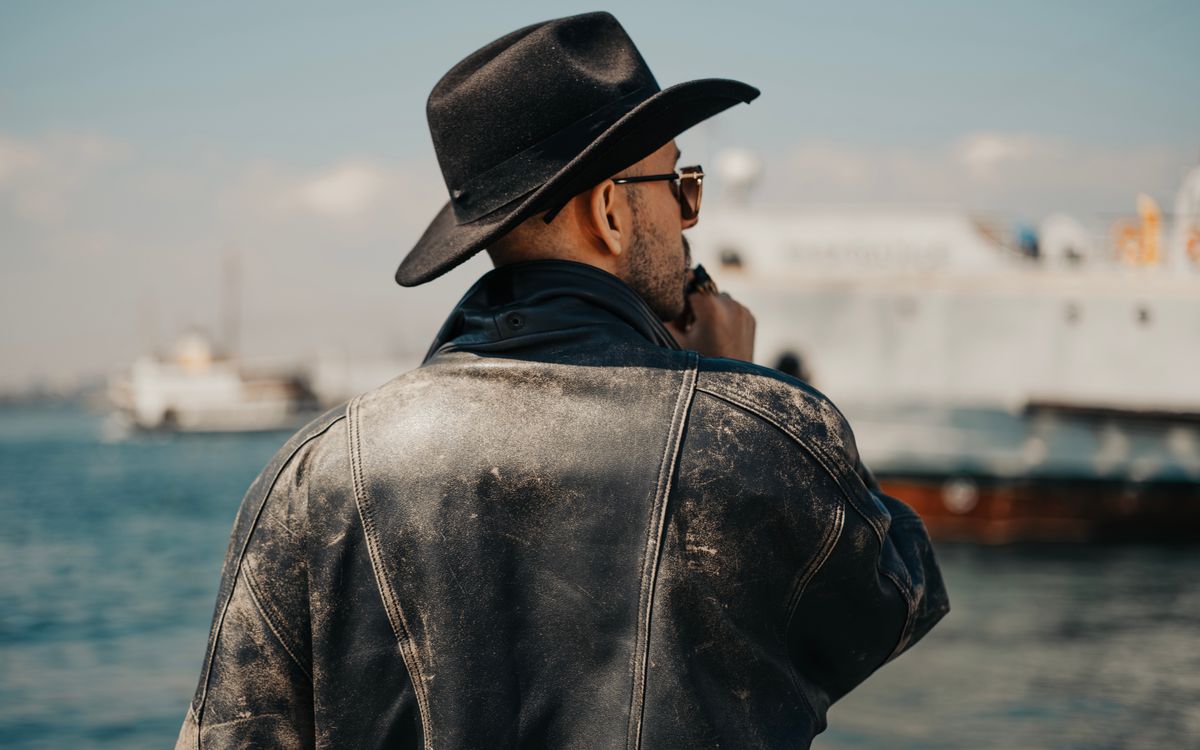 A vintage style leather jacket shown in soft natural light