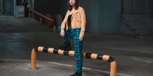 Full length shot of a stylish person standing confidently in a jacket on an urban underground level