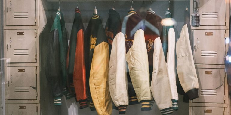 A collection of vintage jackets hanging on a rail, evoking the character of well-worn leather