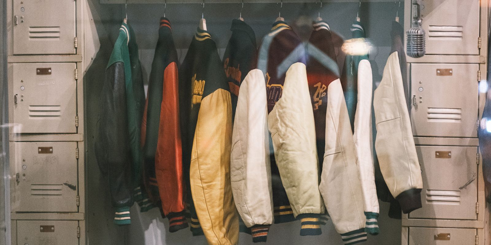 A collection of vintage jackets hanging on a rail, evoking the character of well-worn leather