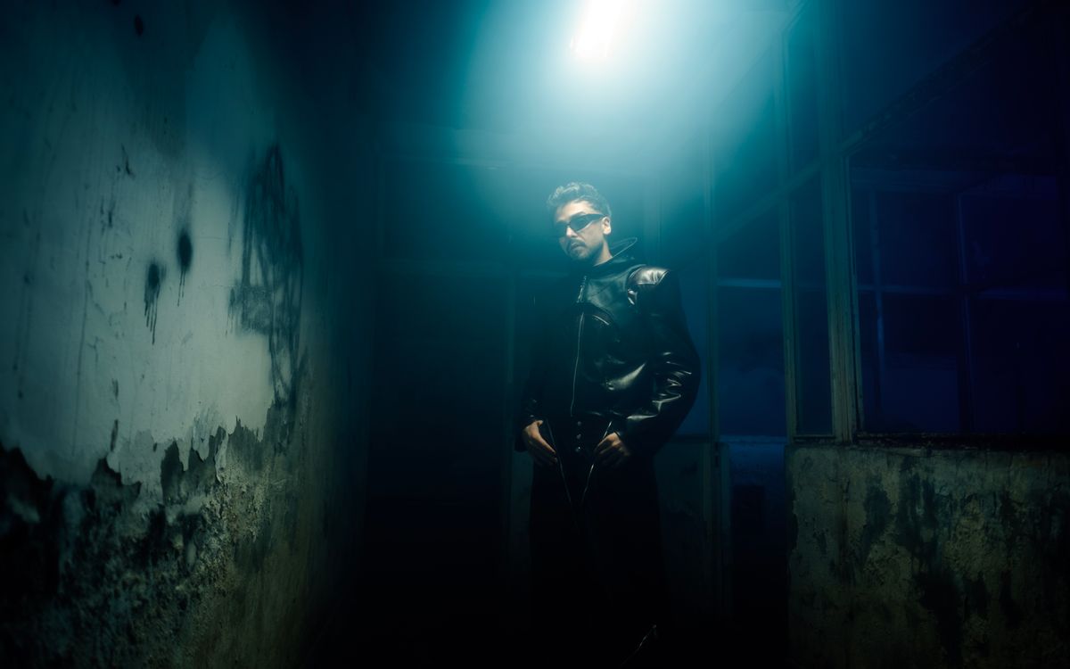 A man in a black leather jacket, moody portrait lighting