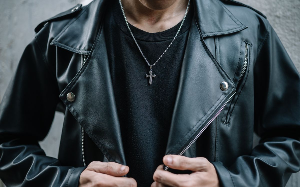 Close-up of a man wearing a black leather jacket, showing the grain and texture