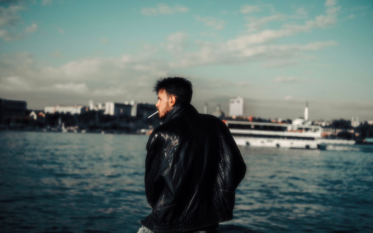 A man in a vintage leather jacket showing the worn character of the hide