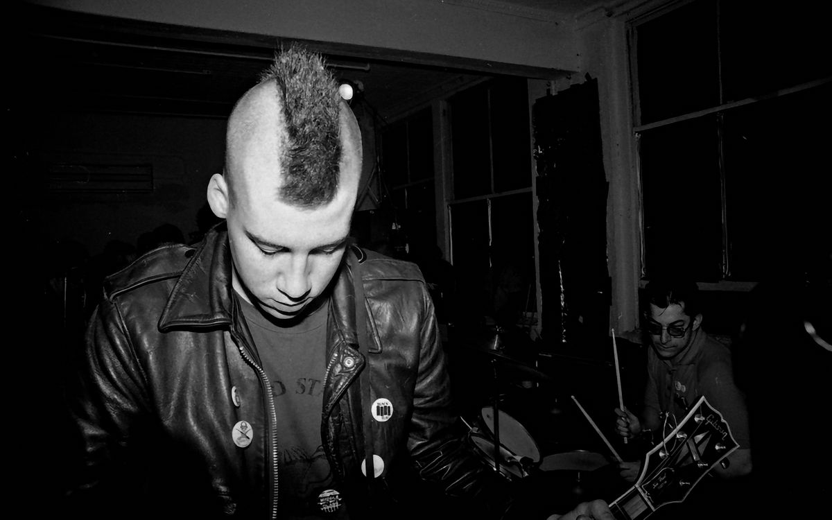 A punk band playing live, black and white photograph
