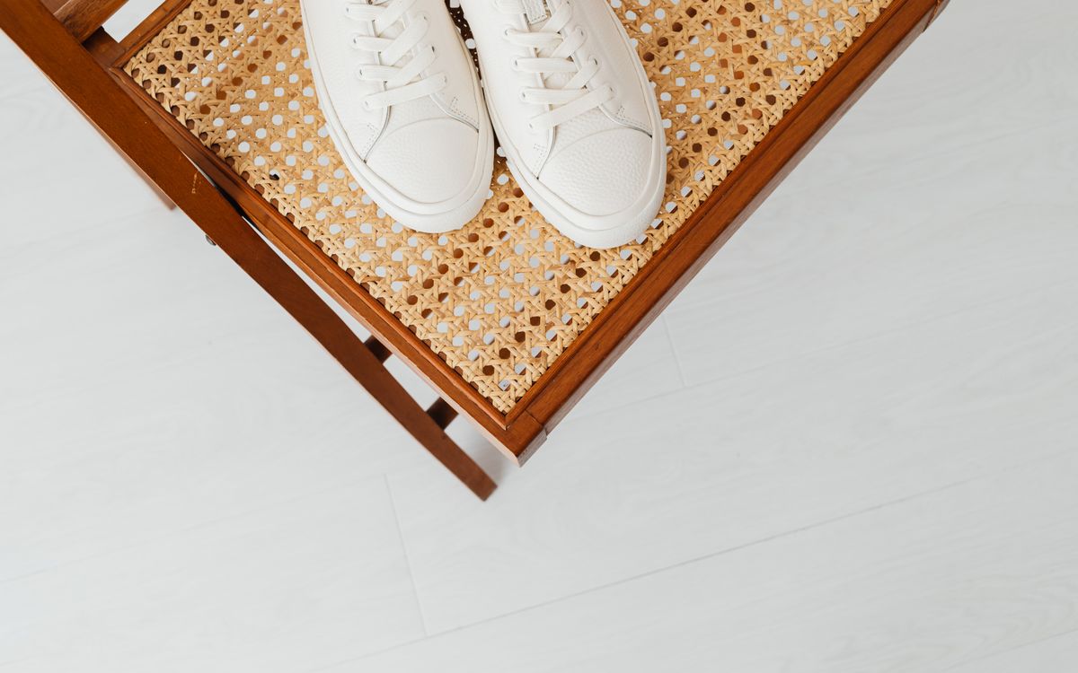 White sneakers paired with casual denim jeans on an urban sidewalk